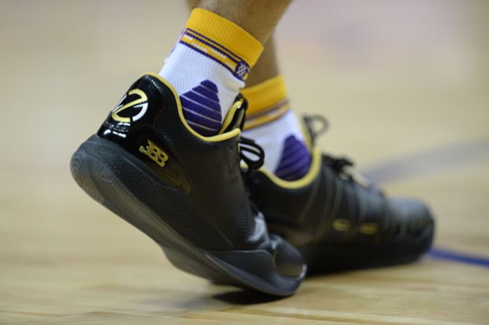 A detailed view of Lonzo Ball's black and gold sneakers.